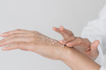 Woman applying clean coconut sugar scrub to hand