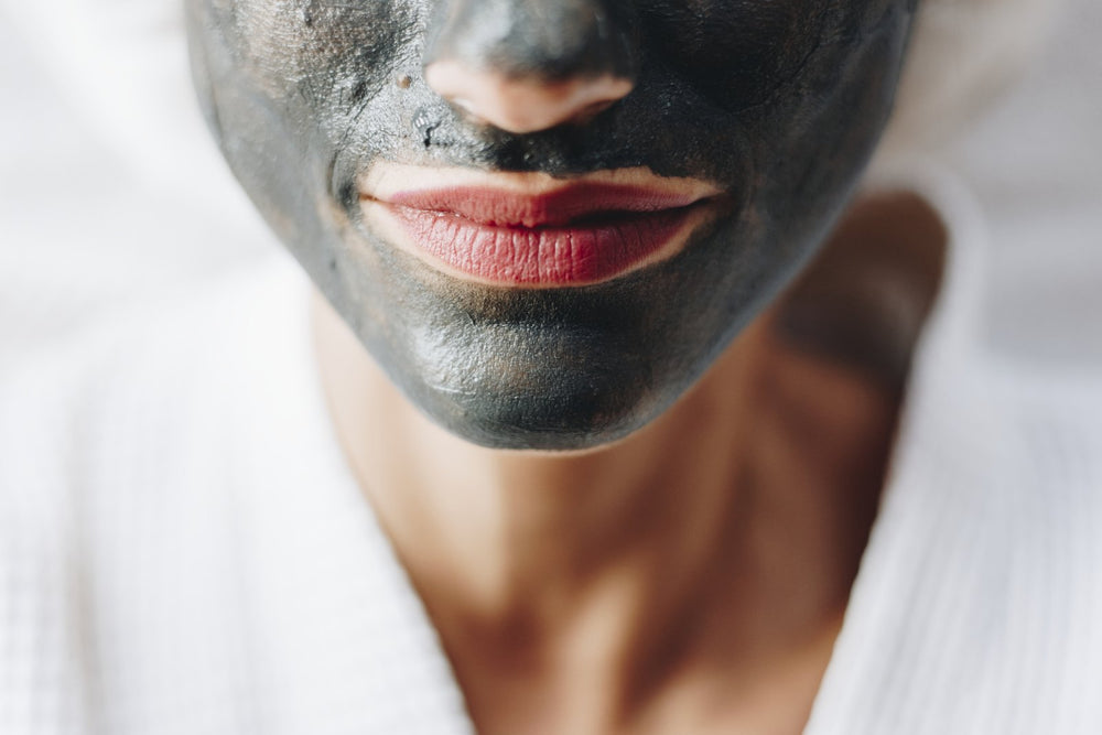 Woman's face wearing clean coconut cbd clay mask